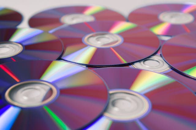 How do CDs and cassettes record information?